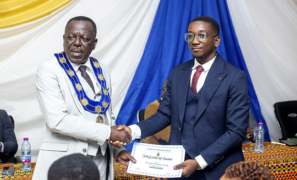 Dr. Jacob Achumboro Ayang (Right) Receiving a Certificate for One of the Awards